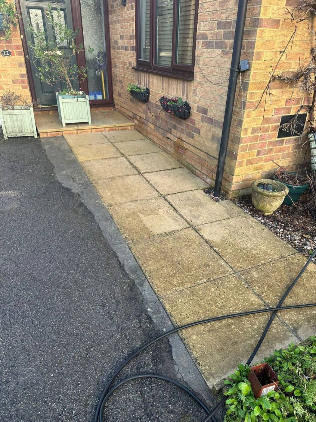 Freshly cleaned garden path slabs after professional pressure washing