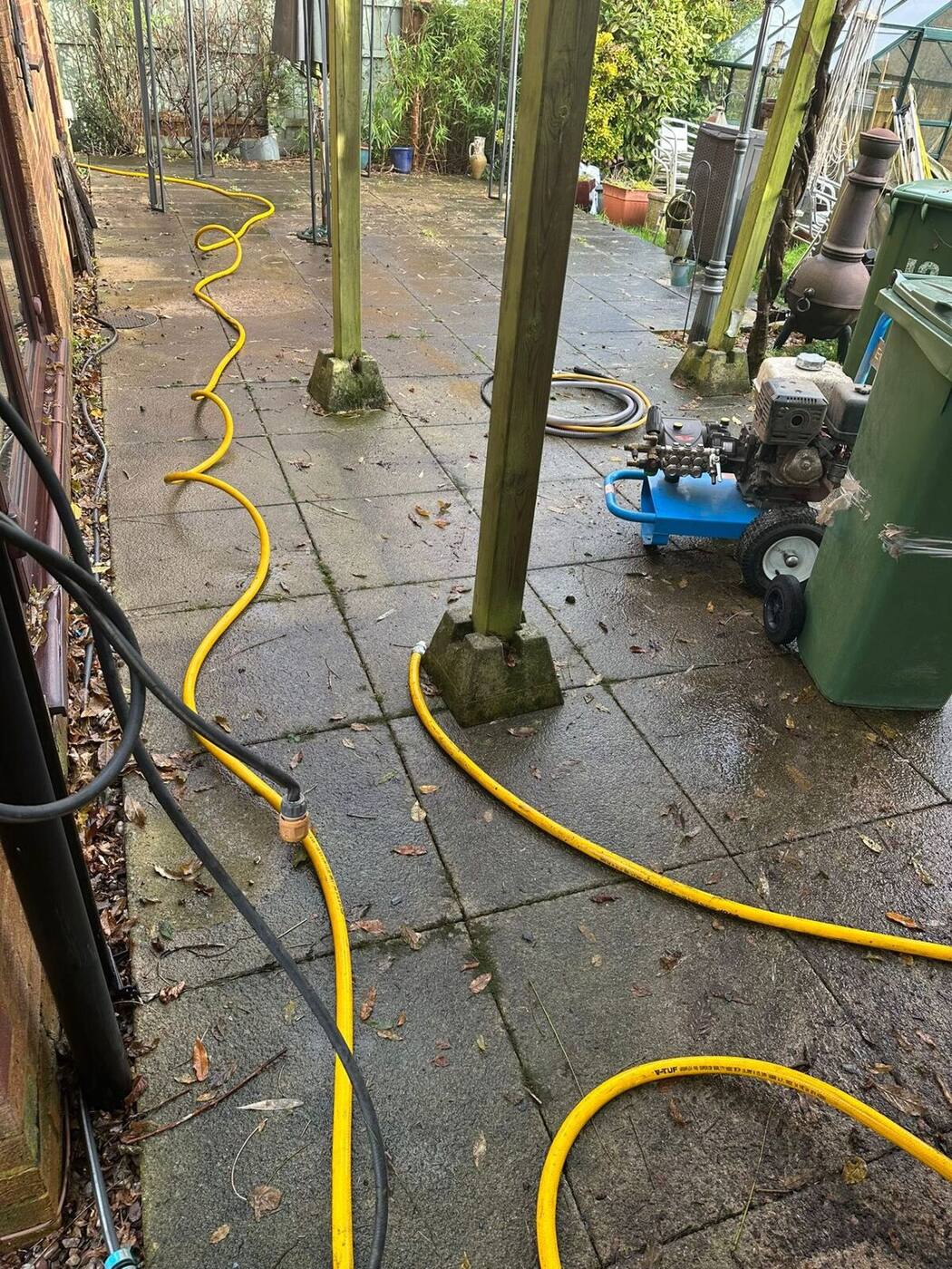 Stained patio surface with organic growth before professional cleaning