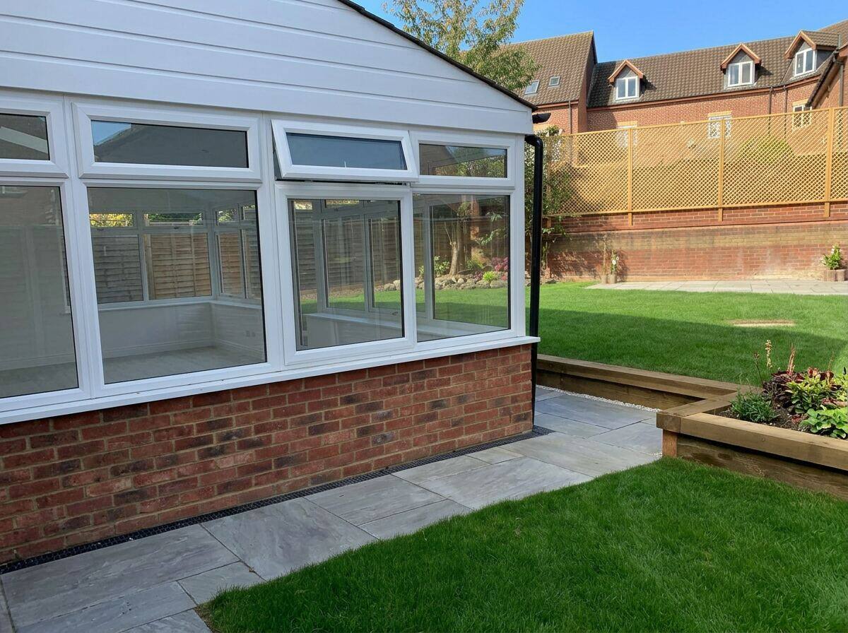 Professional conservatory cleaning equipment beside clean conservatory